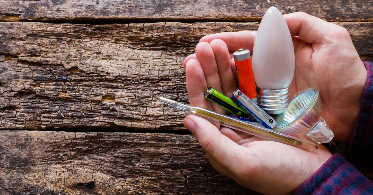 hazardous waste in the hands of a man on a wooden background