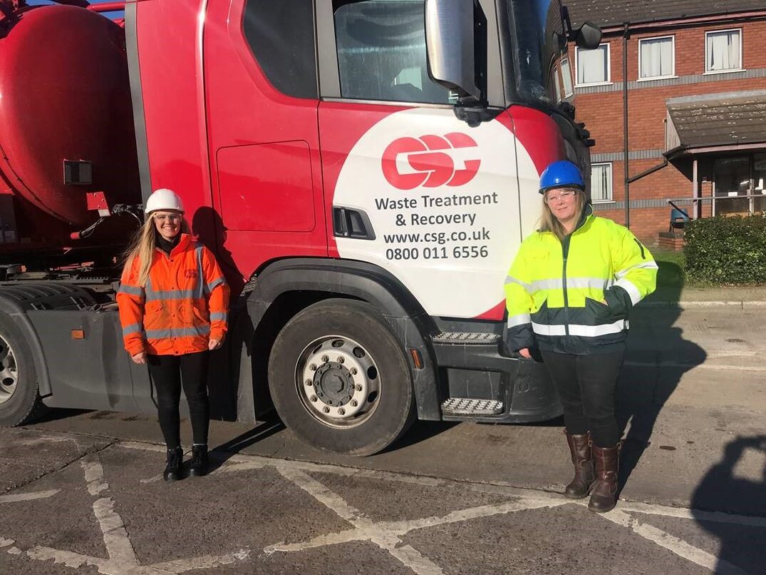 Sam (left) and Cheryl (right) posing in front of a CSG truck.